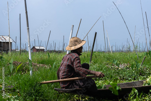 Burmese fisherman travelling in a boat in Inle Lake