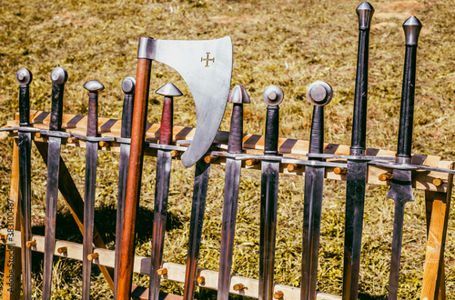 old swords in the wooden rack