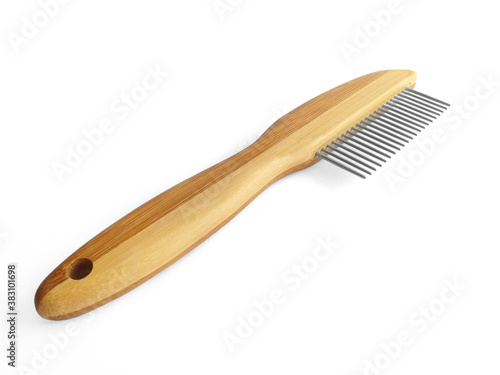 Wooden pet bristle brush isolated on white background. Care of the coat of dogs, cats with a brush of fine metal bristles and joints. Accessory for the grooming of the dog.