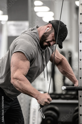 human spirit determination concept of young bearded man pulling heavy weights in sport gym for mass bodybuilding