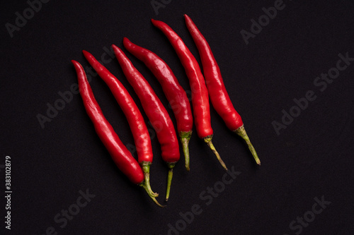 Fresh red chilies on a black background