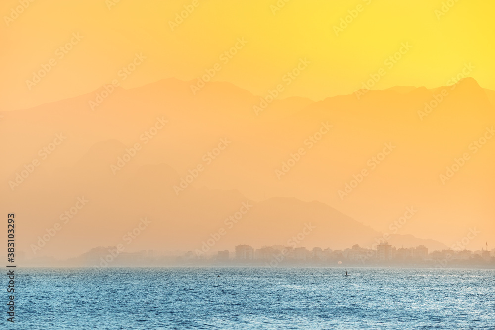 Golden sunset at the mediterranean seacost in Antalya city. Vacation and tour on the Mediterranean coast of Turkey