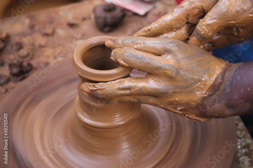 Hands And Fingers Posture Of Potter Making Pottery From Mud Using Spinning Potter Wheel