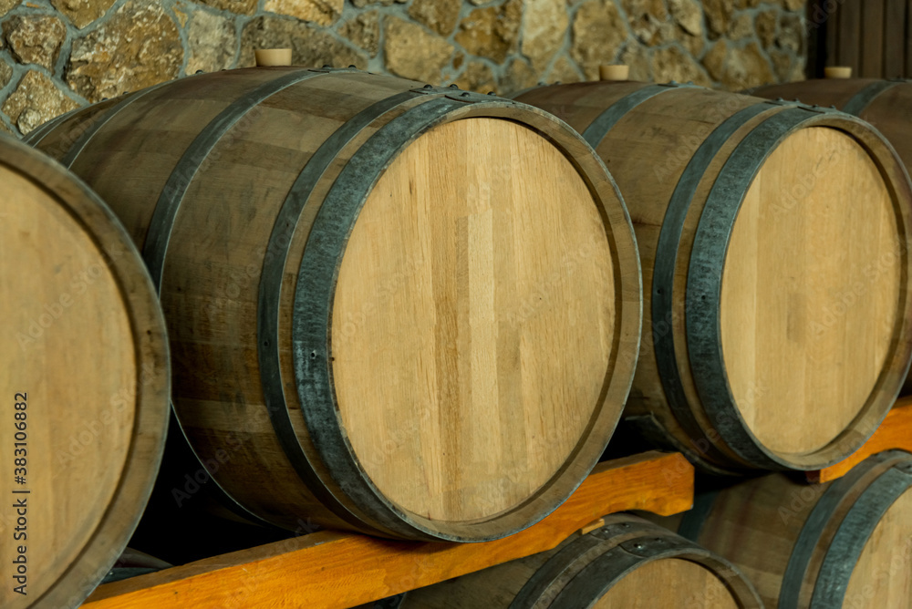 Close up photo of wine barrel laying underground, preparing winery concept Close up photo of wine barrel laying underground, preparing winery concept