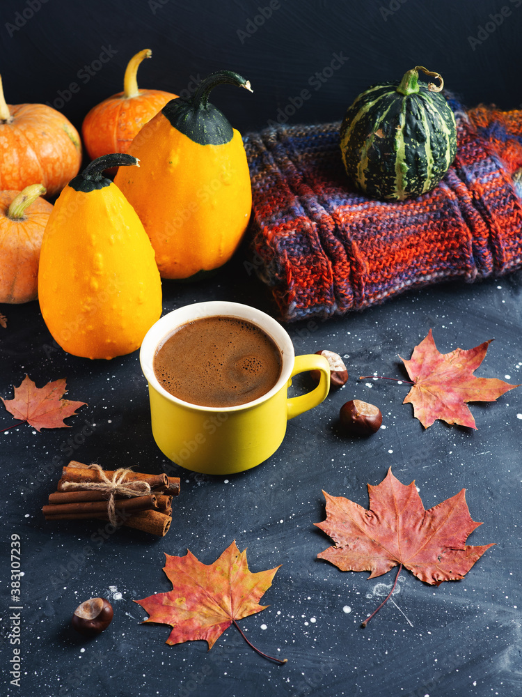 Autumn home comfort . Yellow Cup of hot coffee on the table with pumpkins, knitted scarf and maple red leaves Autumn home comfort . Yellow Cup of hot coffee on the table with pumpkins, knitted scarf and maple red leaves