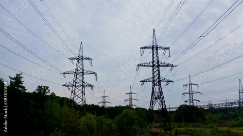 Wallpaper Mural Electricity pylons bearing the power supply across a rural landscape during sunset. Selective focus. Torontodigital.ca