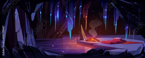 Ice cave in mountain with campfire and sleeping bag, tourist overnight place in grotto with frozen lake and hanging icicles inside. Empty cavern with crystal stalactites. Cartoon vector illustration