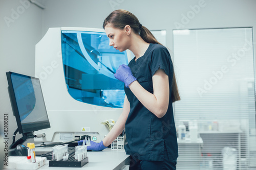 Laboratory assistant looking at the monitor of her computer