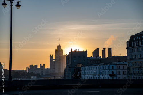 cityscape with ancient buildings and skyscrapers at sunrise
