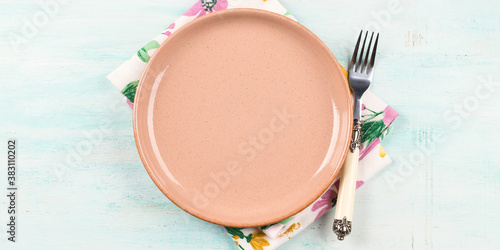 Tablou pe pânză Spring summer table setting with pink dish, fork and floral napkin on turquoise