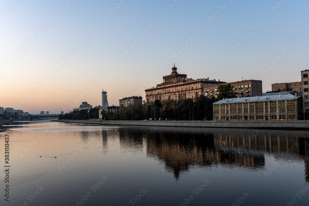 river embankment of a large metropolis at dawn with reflections in the river river embankment of a large metropolis at dawn with reflections in the river