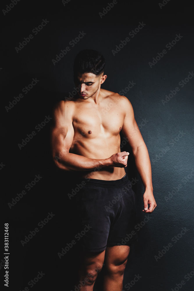 shirtless muscular man on a black background