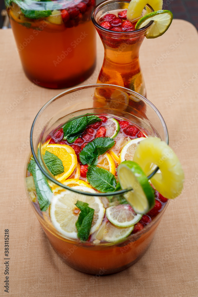 Refreshing lemonade with fresh fruit orange lemon cherry and mint leaves. Delicious non-alcoholic fruit cocktail in a jug Refreshing lemonade with fresh fruit orange lemon cherry and mint leaves. Delicious non-alcoholic fruit cocktail in a jug