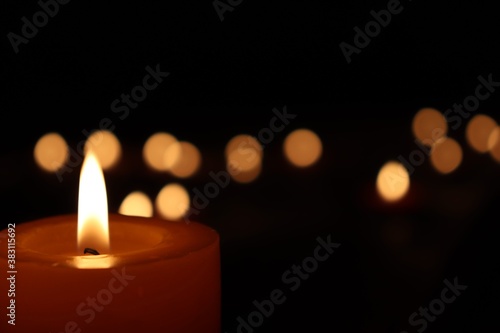 Candle black background of mourning funeral moment of silence