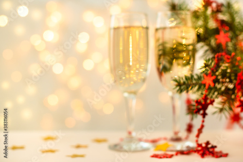 blurred background without focus. glasses of champagne, christmas lights. concept of new year card. copy space