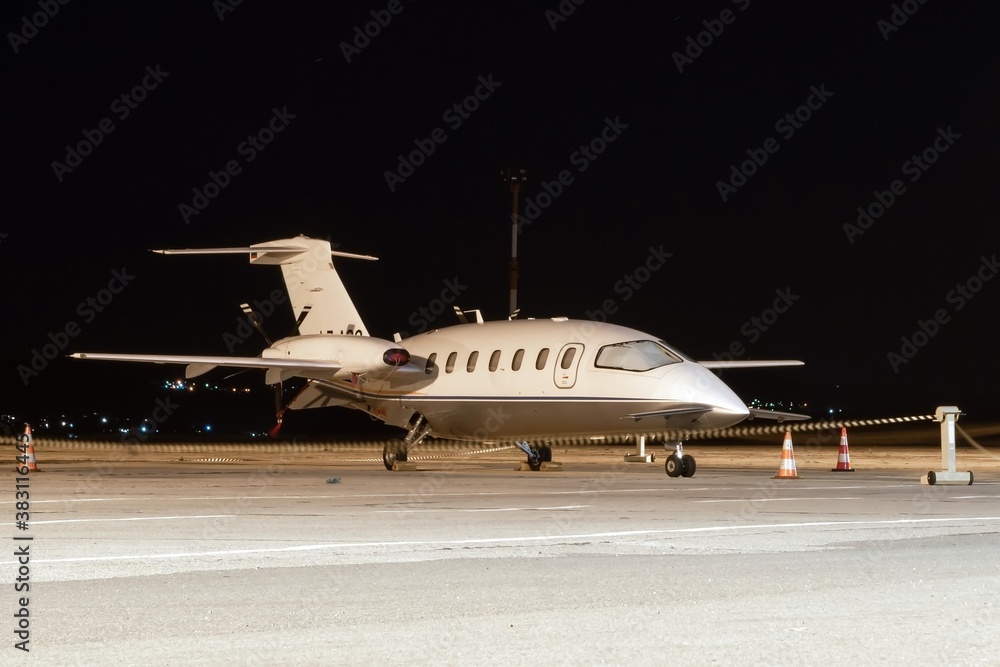 Front side view of white business airplane with twin turboprop engines ...
