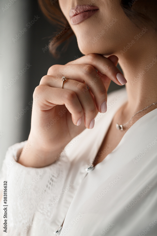 Gentle female hands of the bride with a gold wedding ring on the ring finger Gentle female hands of the bride with a gold wedding ring on the ring finger