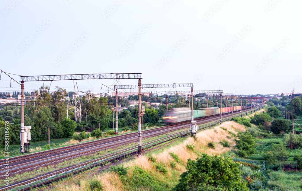 Train with different freight cars that are blurred at high speed Train with different freight cars that are blurred at high speed