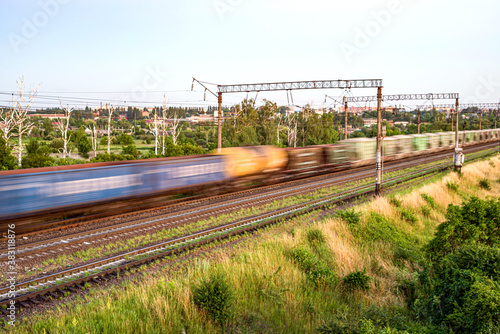 Train with different freight cars that are blurred at high speed