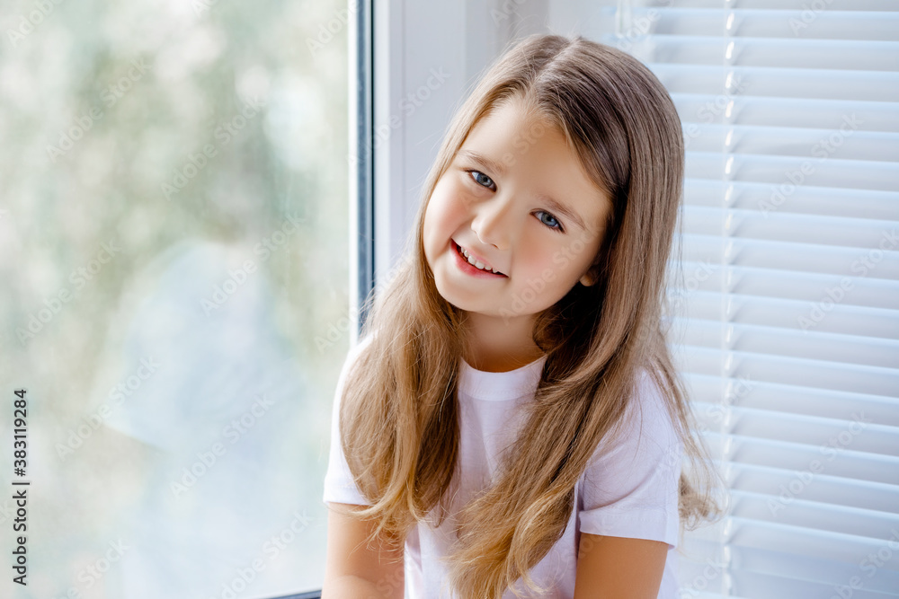 portrait of a happy little girl 4-5 years old smiling.    