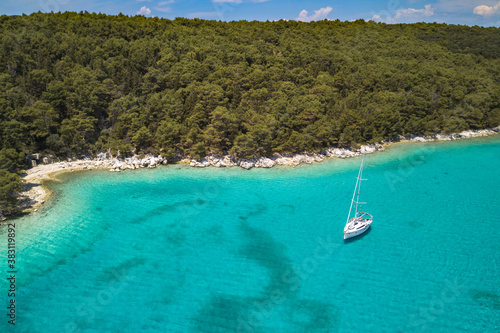 Aerial view on the beautiful bay on Rab island in Croatia. Turquoise color Adriatic sea of Dundo beach in Kampor and yacht in the bay, Rab Island