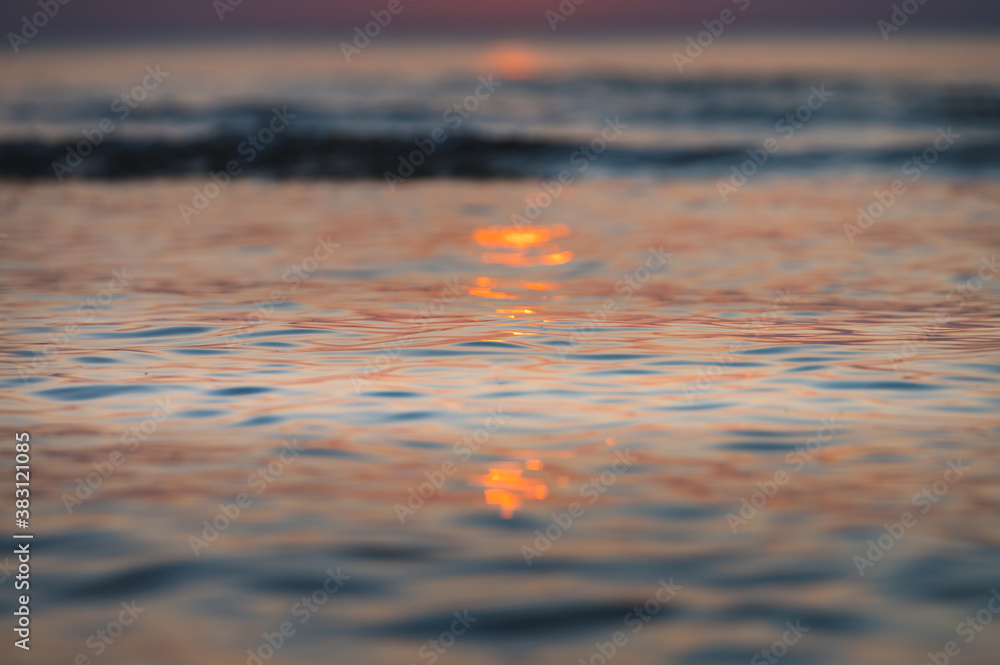 Spacious cave next to Baltic sea glowing in sunset colors. Beach sands and sea in colorful sunset. Spacious cave next to Baltic sea glowing in sunset colors. Beach sands and sea in colorful sunset.