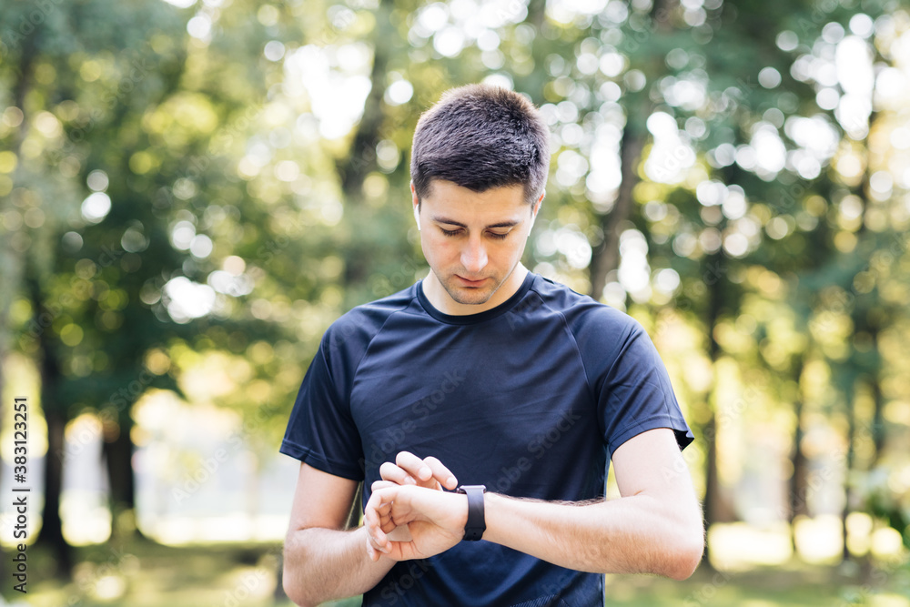 Caucasian man in sports uniform using smartwatch to measure speed ...