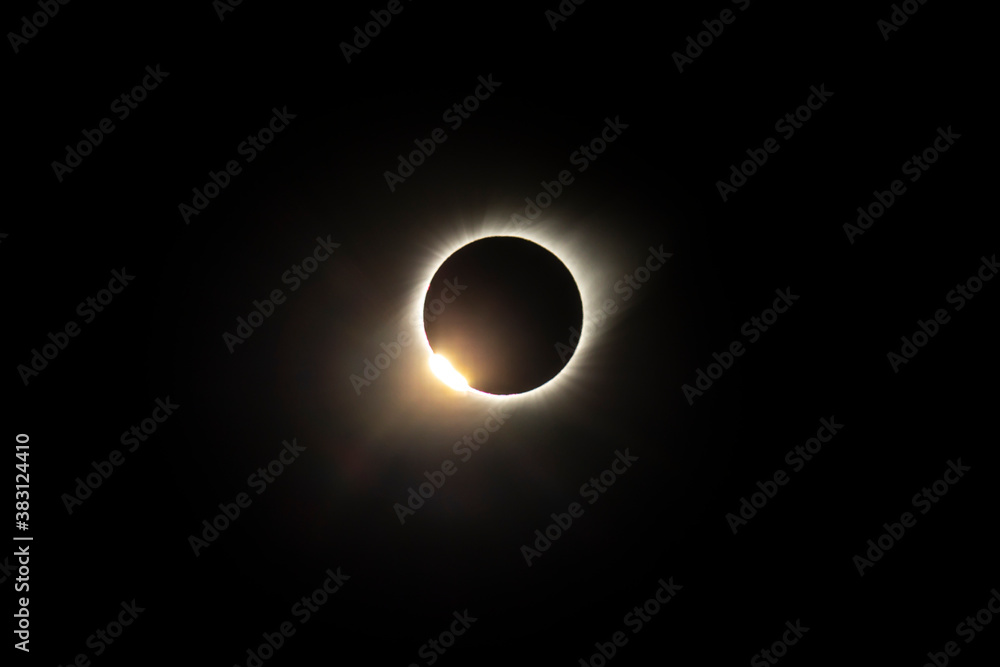 The Baily's beads effect and Diamond Ring effect during Total Solar Eclipse Chile 2019, amazing view of the Sun covered by the Moon during totality phase while the last sunbeams pass the Moon craters The Baily's beads effect and Diamond Ring effect during Total Solar Eclipse Chile 2019, amazing view of the Sun covered by the Moon during totality phase while the last sunbeams pass the Moon craters