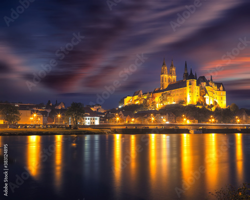 Dramatic view on Albrechtsburg castle and cathedral on the River Elbe during night.