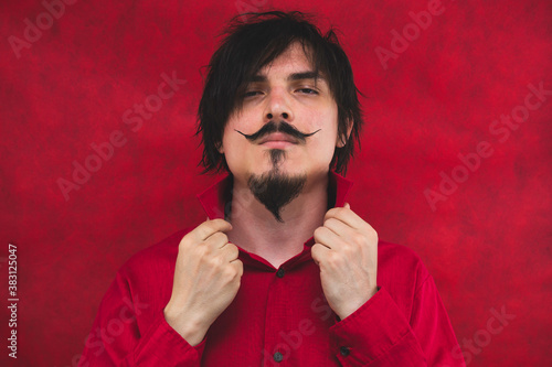 Male portrait. man in red shirt on the red background photo