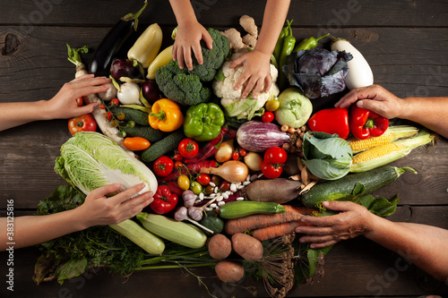 Hands hold the autumn harvest of wholesome food. Local fresh vegetables, assorted for a balanced diet.