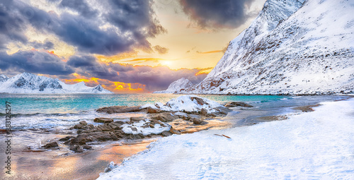Fantastic winter view of Haukland beach during sunset with lots of snow and snowy mountain peaks near Leknes