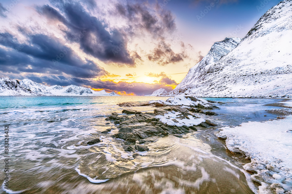Fabulous winter scenery with Haukland beach during sunset and snowy  mountain peaks near Leknes.