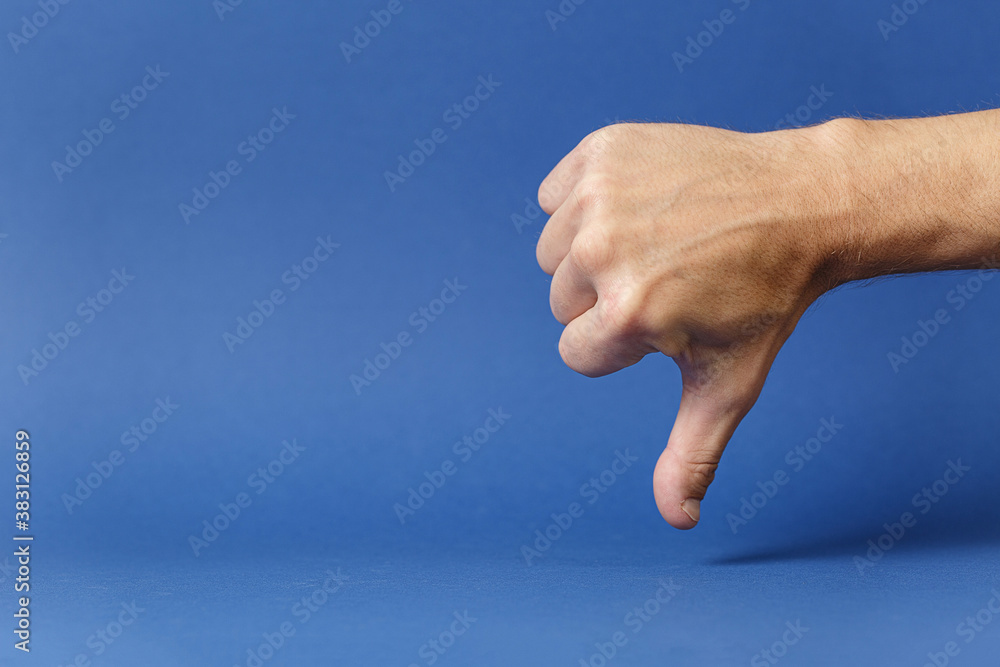 Clenched hand with thumb pointing down disapproval Clenched hand with thumb pointing down disapproval