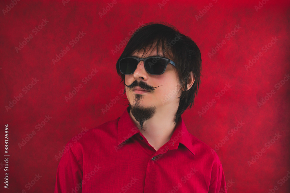 Male portrait. young man with sunglasses in red shirt on the red background Male portrait. young man with sunglasses in red shirt on the red background