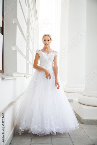 Portrait of a young woman in a white ball gown