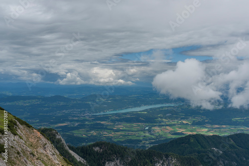 View on Drau river valley from path to Mittagskogel hill in cloudy summer day
