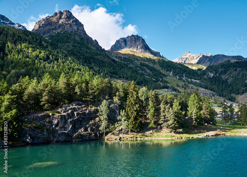 mountain lake of green color in the alps against the background of a chain of mountains © Igor Chalyh