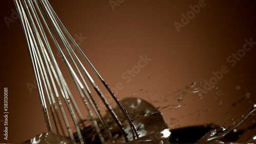 Freeze motion of wire whisk rotating hot melted chocolate