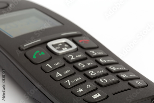 Close up of a wireless telephone with buttons 0 to 9, isolated on white background, landscape format