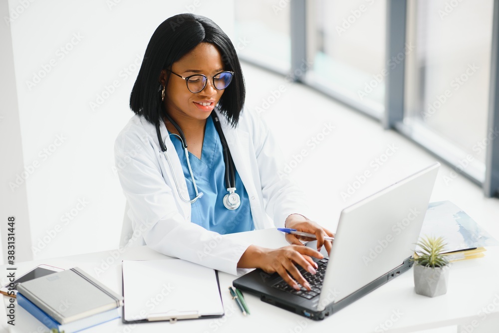 Successful black woman doctor smiling in office Successful black woman doctor smiling in office