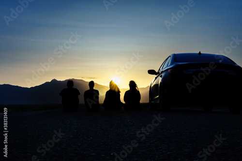  Sunset with friends in the desert. Road trip Concept