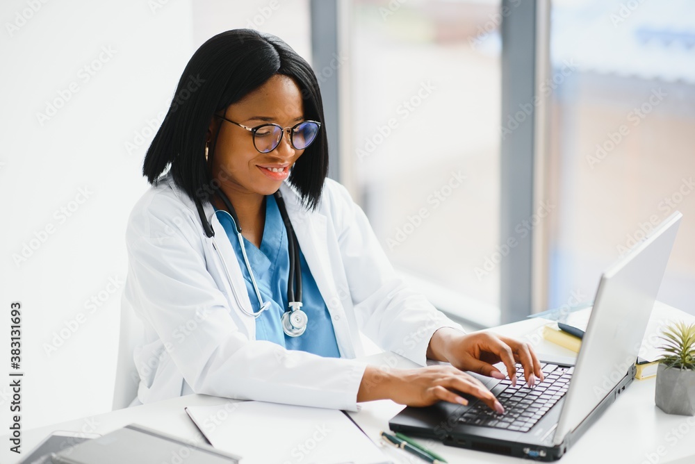Successful black woman doctor smiling in office Successful black woman doctor smiling in office