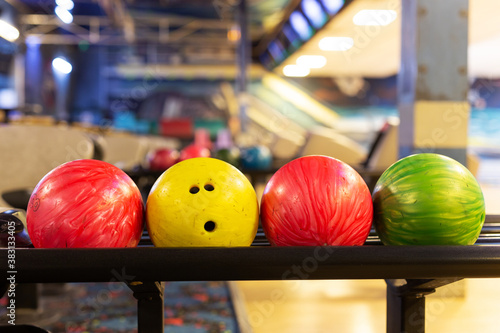 Colored bowling balls on their rail