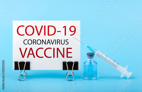 2019-ncov Covid-19 Corona Virus drug vaccine concept. Paper with text COVID-19 VACCINE on blue background.