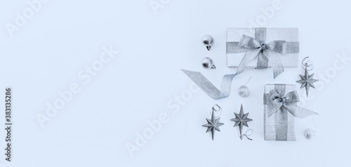Christmas holiday composition in silver blue colors. Christmas ornaments and decorations on blue background. Flat lay  top view  copy space
