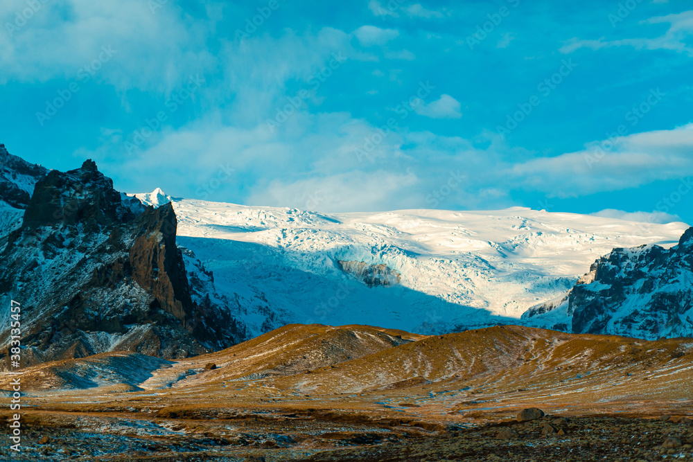 Incredible Icelandic landscapes. Snow-capped mountains and glacier. Sunset.