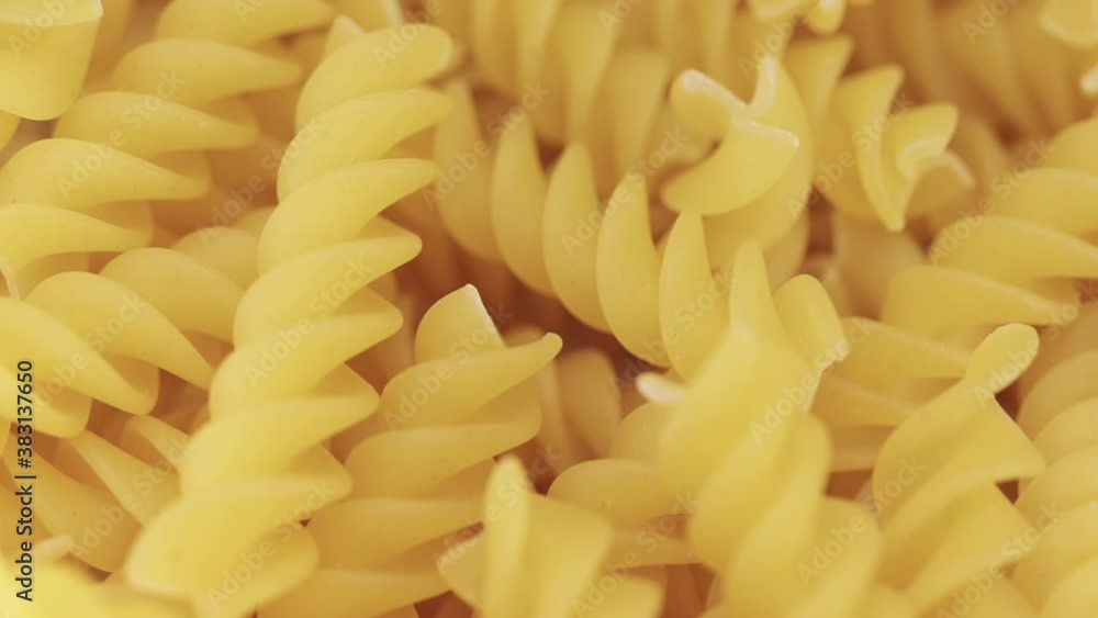 Dry fusilli pasta rotating, macro closeup with a shallow depth of field Dry fusilli pasta rotating, macro closeup with a shallow depth of field