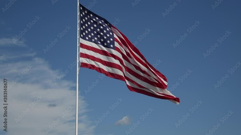 a slow motion video of the American flag blowing in the breeze. a slow motion video of the American flag blowing in the breeze.