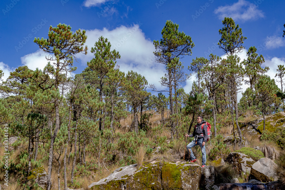 Man with backpack trekking in mountains Man with backpack trekking in mountains